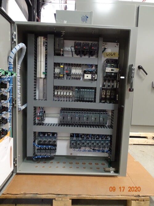 Industrial control panel with electrical components for automotive manufacturing.