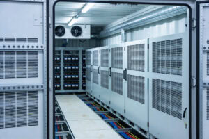 Inside a modern data center with rows of server racks and battery storage