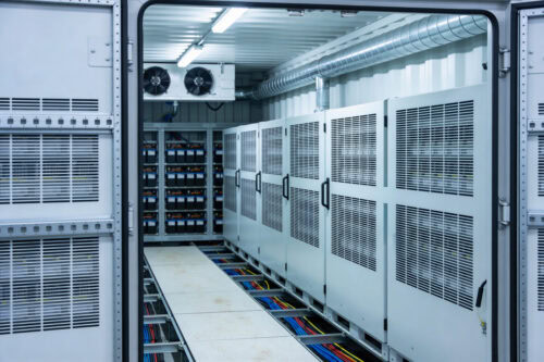 Inside a modern data center with rows of server racks and battery storage Inside a modern data center with rows of server racks and battery storage